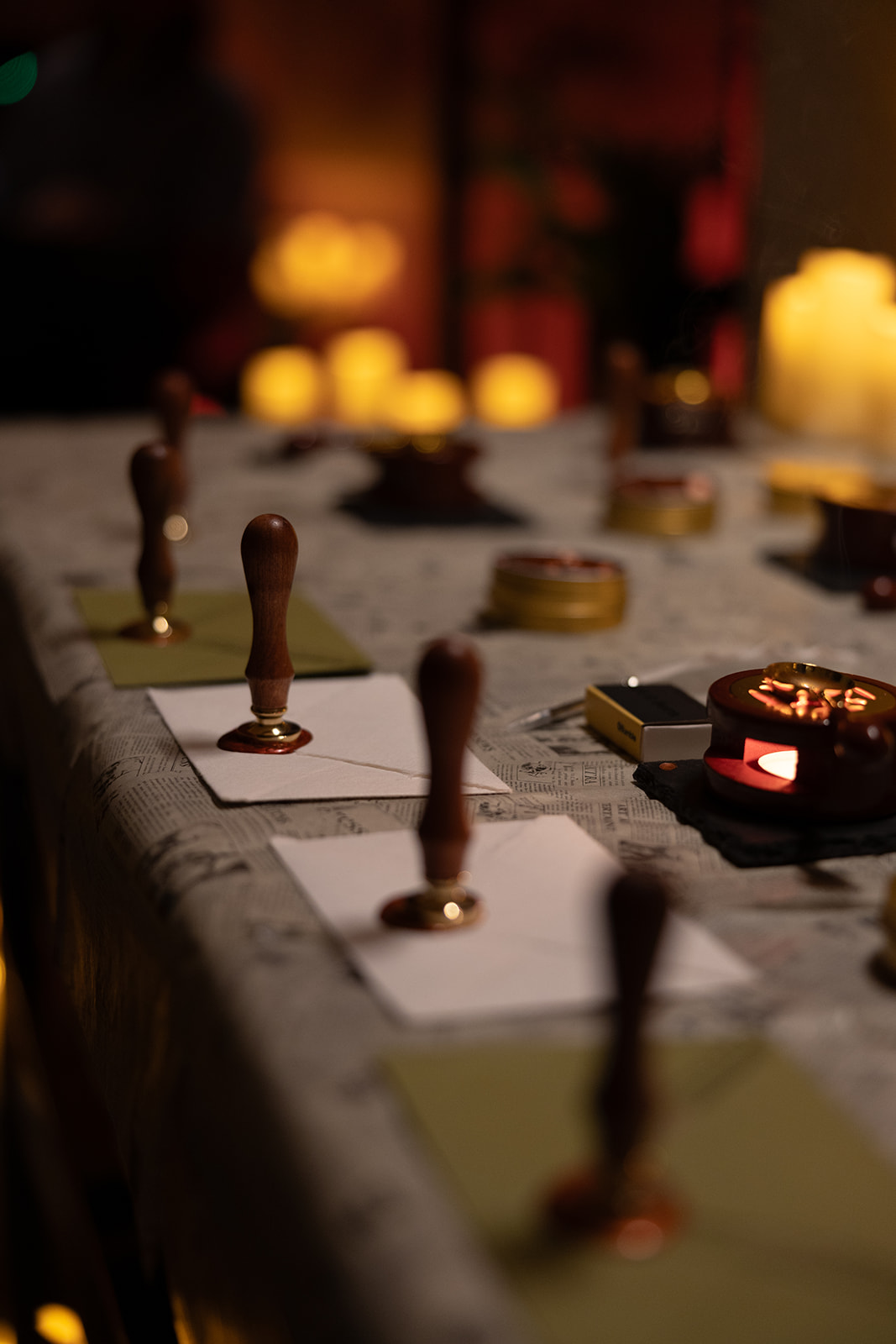 Wax seal stamps pressed onto envelopes during a creative writing ritual.