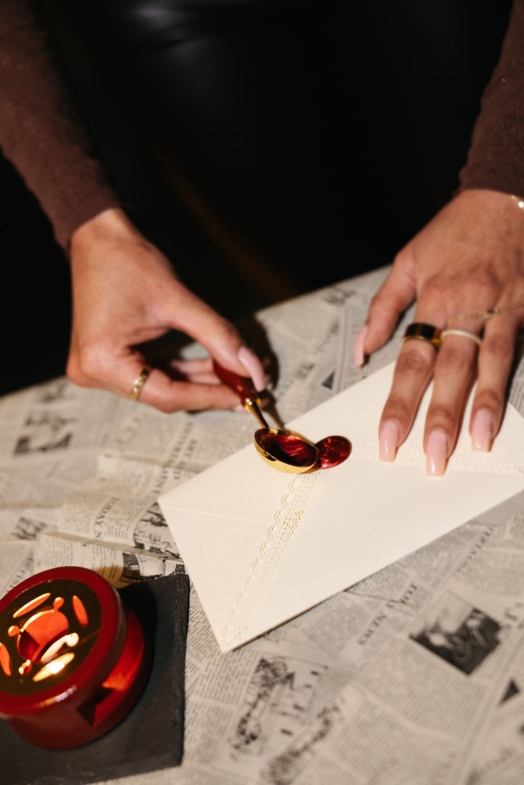 Wax sealing ritual at Typewriters & Bridgerton literary workshop in Toronto featuring vintage correspondence and handwritten letters.